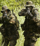 MEMBERS OF GERMAN NAVY SPECIAL OPERATIONS FORCES AIM THEIR WATERPROOF ASSAULT RIFLE